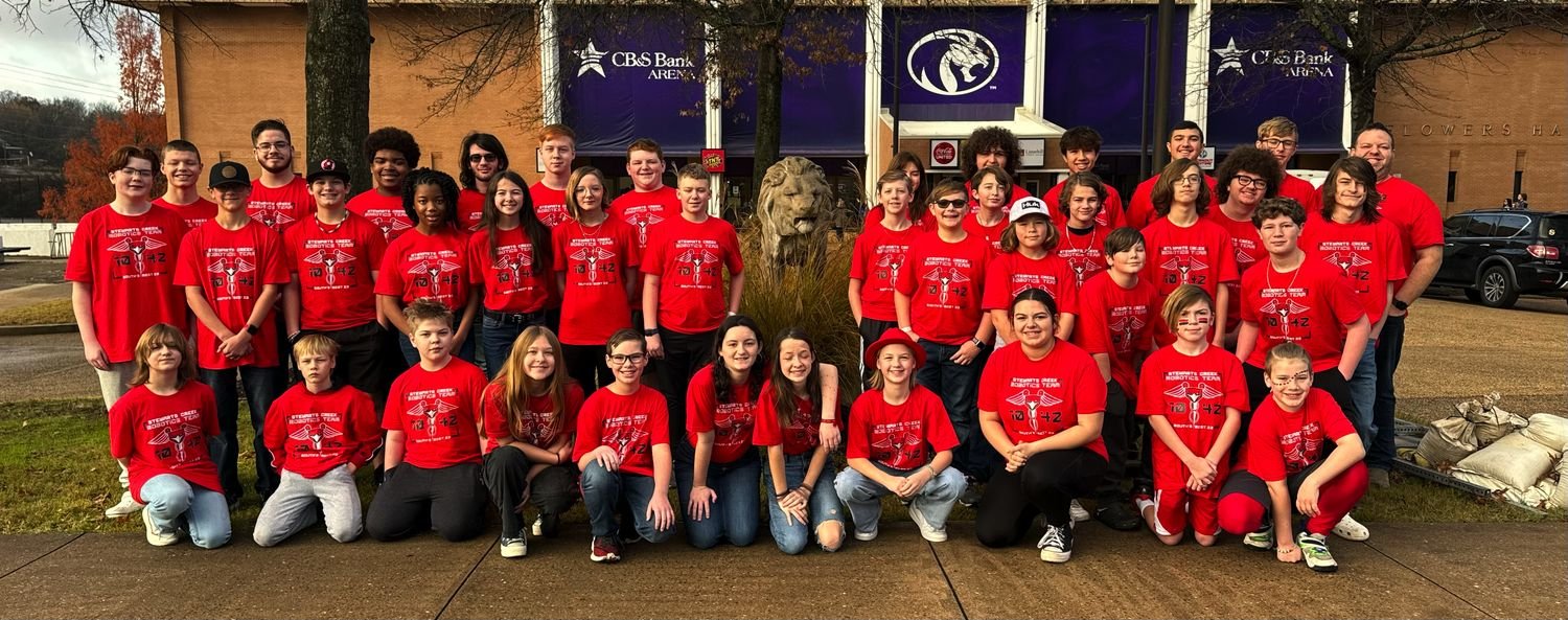 Team members in red team shirts on competition day